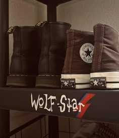 three pairs of shoes are on a shelf with the word wolf - star painted on them