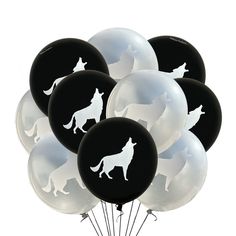 a bunch of black and white balloons with dogs on them