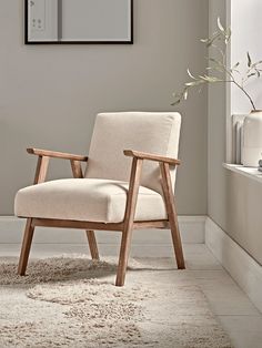 a chair sitting on top of a rug next to a window