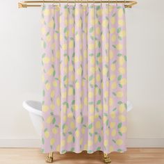 a shower curtain with lemons and leaves on it in pastel pink, yellow and green colors