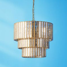 a chandelier hanging from a chain on a blue sky background