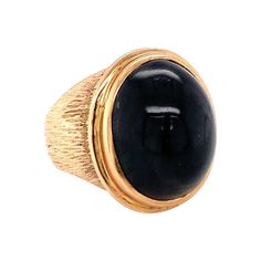 One black sapphire 14K yellow gold cocktail ring featuring one bezel set, oval cabochon black sapphire weighing approximately 30 ct. The mount features a hand-textured, lined finish throughout. Sleek, funky, edgy. Additionbal information: Metal: 14K yellow gold Gemstone: Black Sapphire = 30 ct. Circa: 1960s Size/Measurements: 6.5 ring size Weight: 16 grams Yellow Gold Cocktail Ring, Sapphire Cocktail Ring, Edgy Design, Gold Cocktail Ring, Black Sapphire, Gold Cocktail, Blue Sapphire Diamond, 14k Rose Gold Ring, Diamond Cocktail Rings