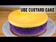 a purple and yellow cake sitting on top of a silver plate with the words, ube custard cake