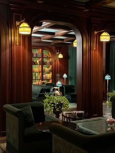 a living room filled with lots of furniture and bookshelves next to each other