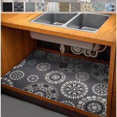 a kitchen sink under a counter with place mats