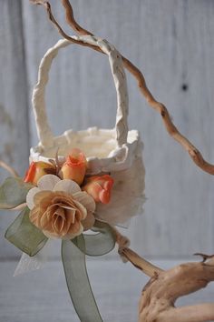 a small basket with flowers and leaves on it