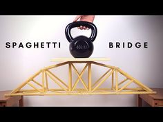 a black kettle sitting on top of a wooden bridge with the words spaghettitti bridge above it