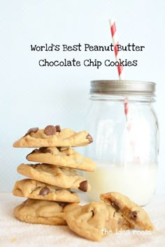 chocolate chip cookies stacked on top of each other in front of a jar with milk