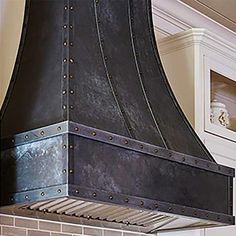 a large black stove top oven sitting inside of a kitchen