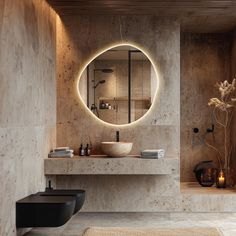 a bathroom with a round mirror above the sink and lights on the wall behind it