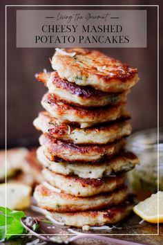 stack of cheesy mashed potato pancakes with lemon wedges on the side