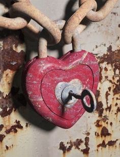 a red heart shaped padlock attached to a chain