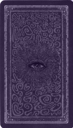 an eye is shown in the middle of a purple book with swirls on it