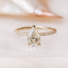 a ring with a pear shaped diamond on it