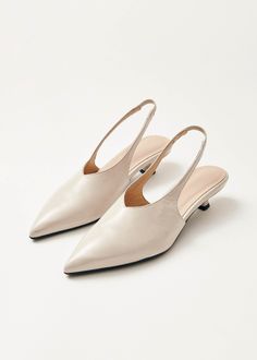 Cream crinkle-effect leather slingback pumps Crafted from cream crinkle-effect leather, the Eros pumps rest on a low 4mm heel and feature an elasticated slingback strap, ensuring non-negotiable comfort. The sharply pointed toe and minimalist, long vamp add the touch for an elegant silhouette. Finnish Fashion, Hand Towels Kitchen, Wedding Pumps, Color Crema, Knit Alpaca, Knit Bottom, Weekender Tote Bag, Naha, Half Zip Sweaters