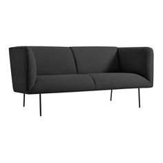 a black couch sitting on top of a white floor next to a wooden frame and metal legs