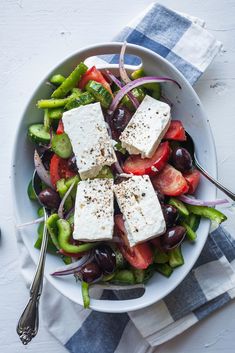 a salad with feta cheese and olives in a bowl