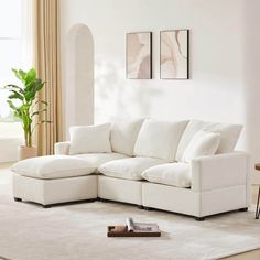 a living room with a large white sectional couch