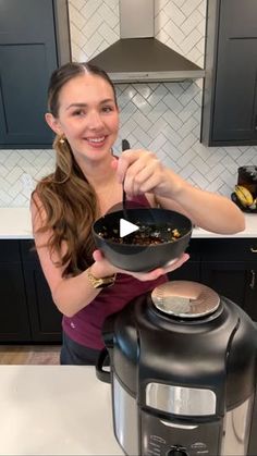 a woman holding a frying pan with food in it