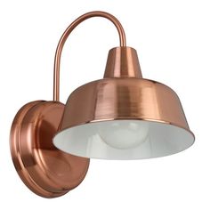 a copper wall light with a white glass shade