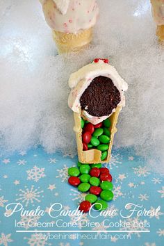 some cupcakes and candy are in the shape of an ice cream cone on a table