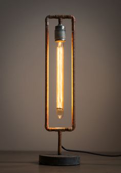 an old fashioned light bulb is turned into a lamp that's on top of a table