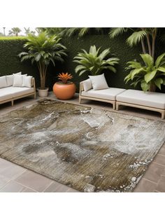 a living room area with couches and potted plants