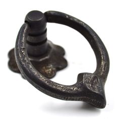 an old black metal hook on a white background