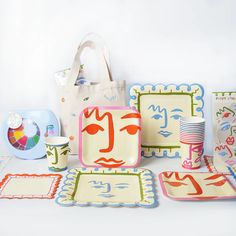 a table topped with assorted plates and cups