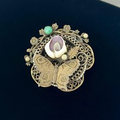 🌼 Such a gorgeous piece.  1940s round brooch, that can be converted to a necklace pedant, gold tone with butterfly, faux pearls, as filigree floral frame.   🌼 Measures: 2 1/8" diameter. 🌼 Condition: good. some wear on the finish. Please see photos for complete condition. To view more vintage jewelry and boxes in my shop, please visit: https://www.etsy.com/shop/TheVintageDaisyVault?ref=seller-platform-mcnav§ion_id=25440304 Vintage Medallion Brooch For Wedding, Vintage Medallion Brooches For Wedding, Vintage Filigree Pendant Brooch, Vintage Filigree Pendant Brooches, Vintage Pendant Brooches With Intricate Design, Antique Round Brooch With Intricate Design, Antique Brooches With Intricate Design, Antique Gold Brooches From Vintage Collection, Antique Round Brooches With Intricate Design