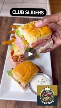 a person is holding up a sandwich on a plate