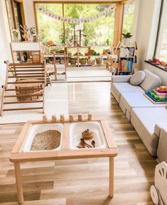 a living room filled with furniture and lots of windows