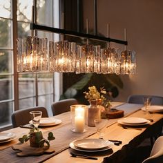 a dining room table is set with plates and place settings