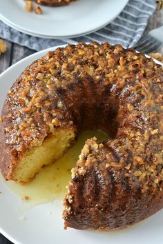 a bundt cake on a white plate with one slice cut out and half eaten