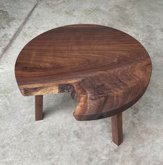 a wooden table sitting on top of a cement floor