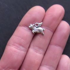 Flying pig antique silver tone charms, in a zinc alloy metal. Measurements: 15mm x 10mm Hole Size: 2mm You will receive 12 charms. Need more? Just send us a message through the contact us form, instant chat, or at mailto:info@bohemianfindings.com. Bulk pricing is available! All of our products are lead and cadmium free and nickel safe. As they contain small parts, all items are for adult jewelry/craft making use only, not intended for children under the age of 15. Pigs Fly, Cute Piggies, Flying Pig, Zipper Pulls, Pigs, Crafts To Make, Zinc Alloy, Jewelry Crafts, Floral Rings