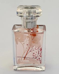 a bottle of perfume sitting on top of a white table