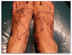 two feet with tattoos on them and one has a world map