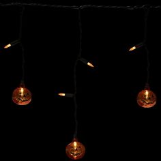 halloween pumpkin lights hanging on a string in the dark