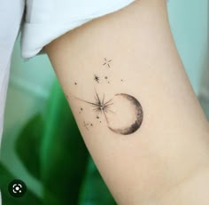 a small dandelion tattoo on the left side of the arm, with stars and a crescent