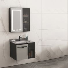 a bathroom with a sink, mirror and cabinet in the wall next to tiled floor