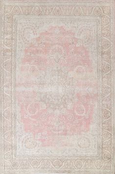 an antique rug with pink and white colors