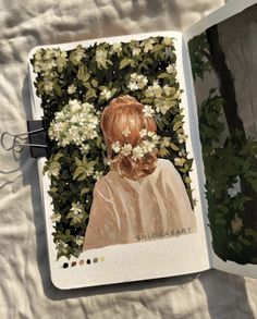 an open book with a painting of a girl and flowers