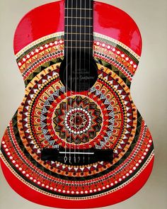 a red guitar with an intricate design on it