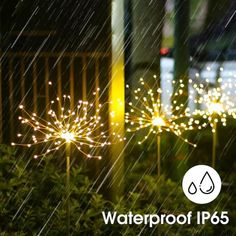 two fireworks are lit up in the rain with water drops on them and there is a sign that says waterproof ip65