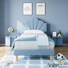 a child's bedroom with blue walls and furniture