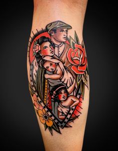 a tattoo on the leg of a man with an image of a woman and child