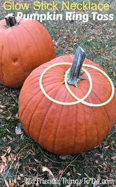 two pumpkins with rings on them sitting in the grass