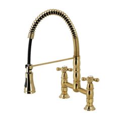 a kitchen faucet with gold fixtures and black handles