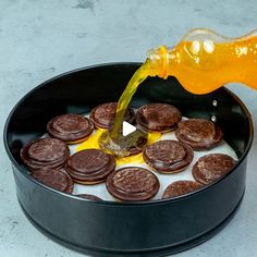 a pan filled with cookies and syrup being poured into it